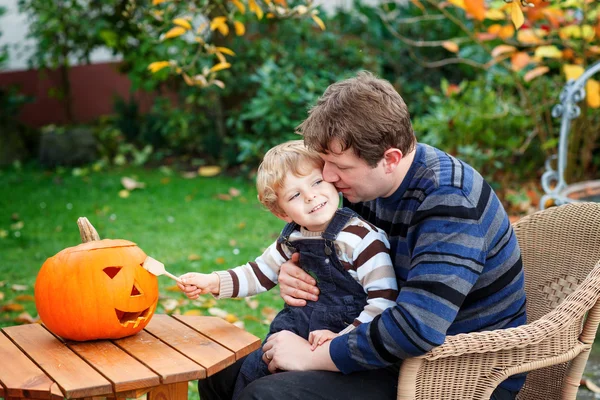 Mladý muž a batole chlapec díky halloween dýně — Stock fotografie