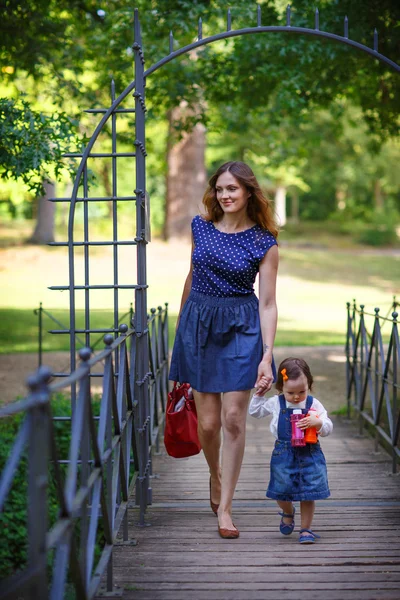 Vacker mor och dotter går i sommar park — Stockfoto