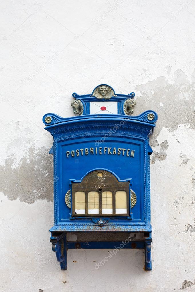 Antique blue wall mailbox on white background