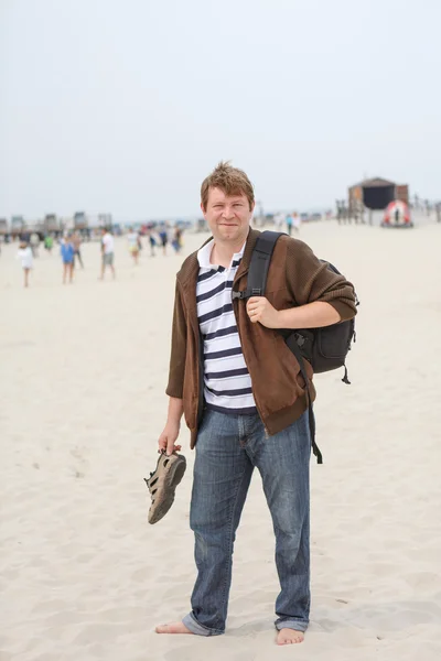 Young happy man on the beach of St.Peter Ording, North Sea, — Stock Photo, Image