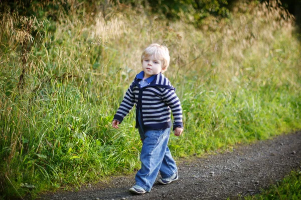 Little blond boy near forest lake, on summer evening — Stock Photo, Image