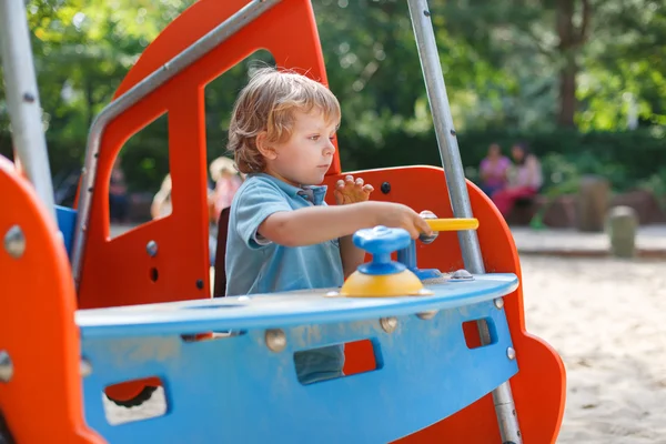 Little boy having fun on city playground on sunny day — Stock Photo, Image