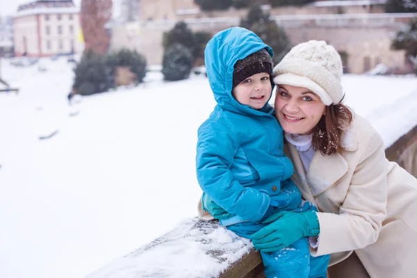 Mother and toddler boy having fun with snow on winter day — Stock Photo, Image