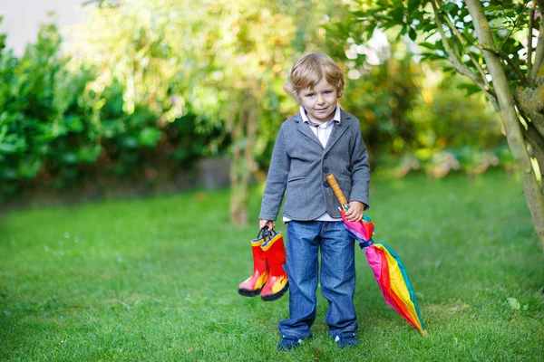 Little cute toddler boy with colorful umbrella and boots, outdoo — Stock Photo, Image
