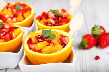 Fruit salad in hollowed-out orange clipart