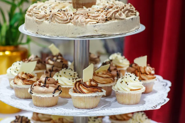 Wedding cake and cupcakes in brown and cream.