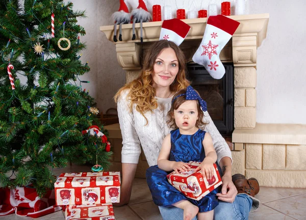 Little girl and mother with Christmas tree and decoration