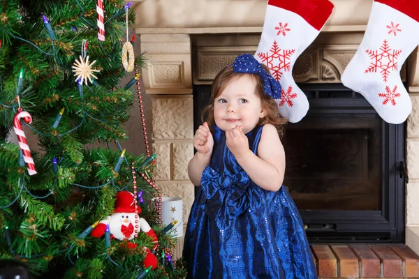 Klein meisje gelukkig over kerstboom en verlichting — Stockfoto