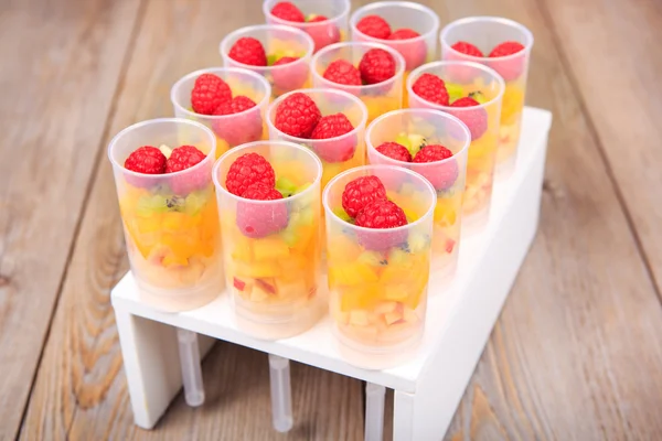 Fruit salad in push up cake forms — Stock Photo, Image