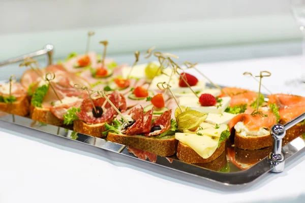 Different tasty snacks on luxury banquet table Stock Photo