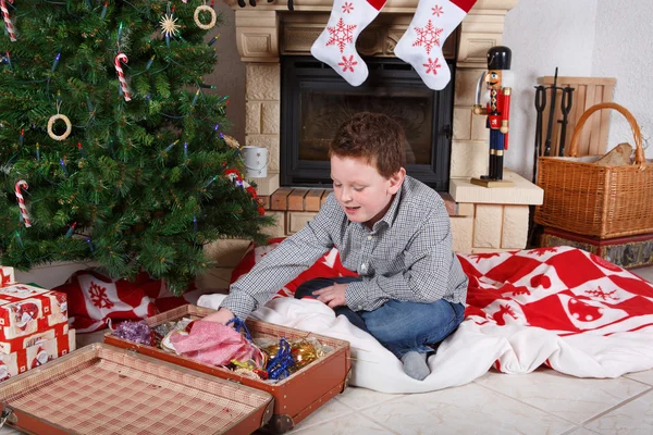 Beautiful school boy decorating Christmas tree — Stock Photo, Image