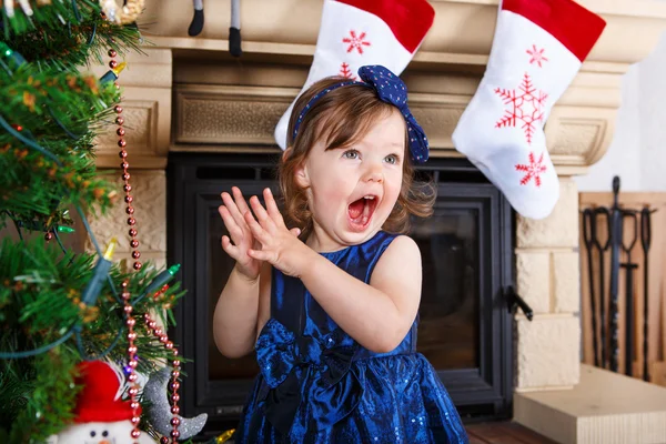 Menina sendo feliz sobre árvore de natal e luzes — Fotografia de Stock