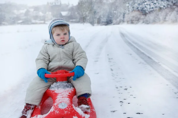 Little toddler boy having fun with snow outdoors on beautiful wi — Stock Photo, Image