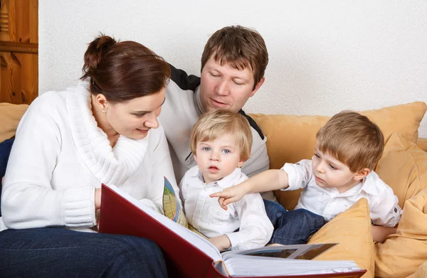 Happy family of a four planning traveling together. — Stock Photo, Image