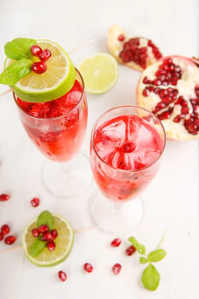 Two glasses with red pomgranate champagne, lime and mint. — Stock Photo, Image