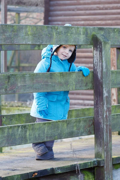 Cute toddler boy walking on wooden bridge — Stock Photo, Image