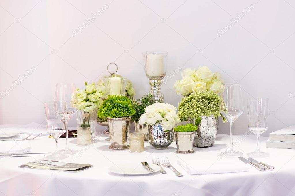 Elegant table set in green and white for wedding or event party.