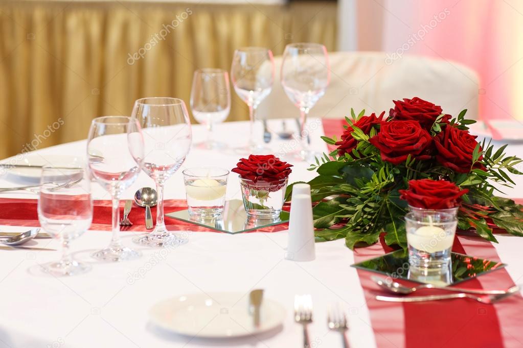 Elegant table set in red and white for wedding or event party.