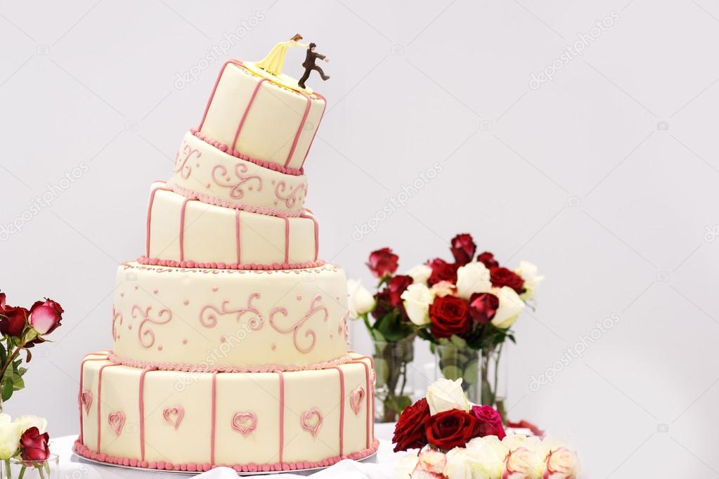 Delicious wedding cake in white , creme and pink