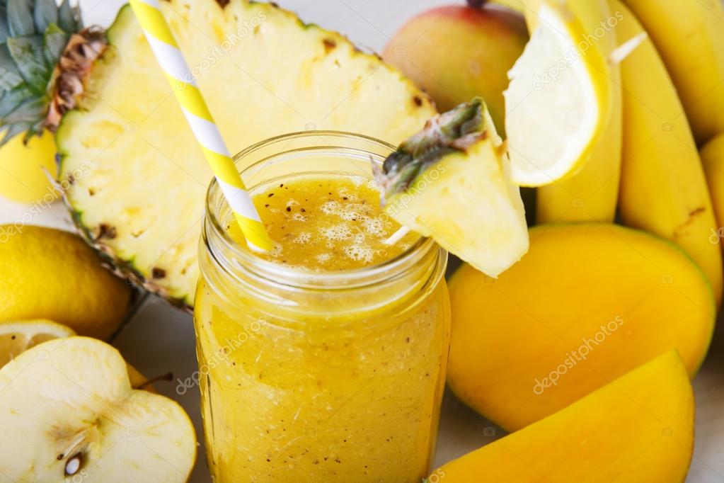 Fresh organic yellow smoothie with banana, apple, mango, pear, p