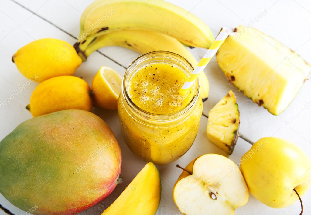 Fresh organic yellow smoothie with banana, apple, mango, pear, p