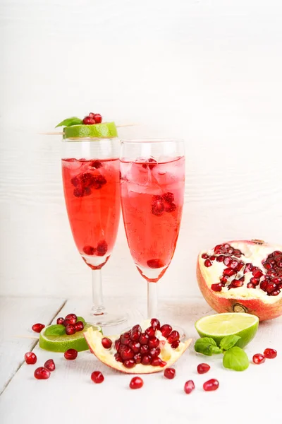 Two glasses with red pomgranate champagne, lime and mint. — Stock Photo, Image