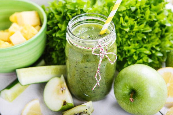 Fresh organic green smoothie with salad, apple, cucumber, pineap