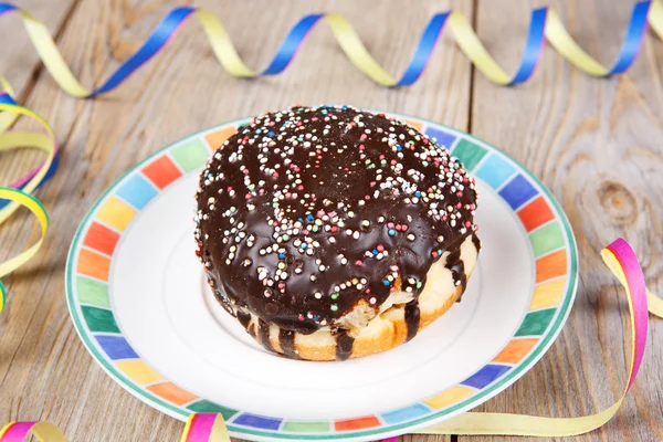 Chocolate and coconut donuts with carnival decoration. — Stock Photo, Image