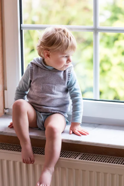 Adorable niño mirando por la ventana — Foto de Stock