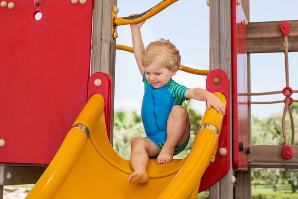 Little toddler boy sitting on playground — Stock Photo, Image