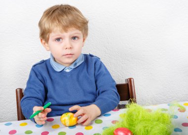 biraz yürümeye başlayan çocuk boyama renkli yumurta Paskalya için AVI