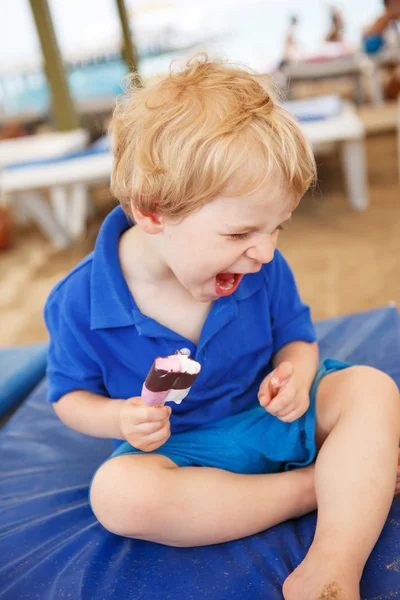 Little blond toddler eating chocolate ice cream — Stock Photo, Image