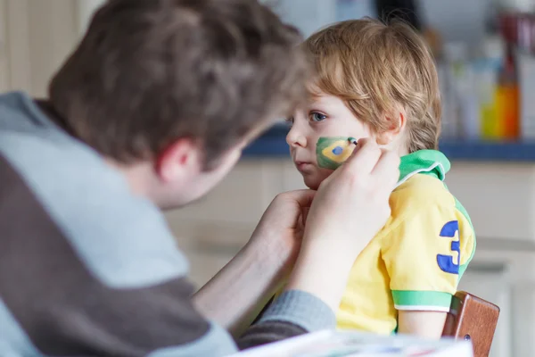 Padre che dipinge bandiera sul volto del piccolo figlio — Foto Stock