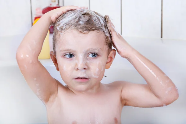 Cute little toddler boy of two years having fun by taking bath i — Stock Photo, Image