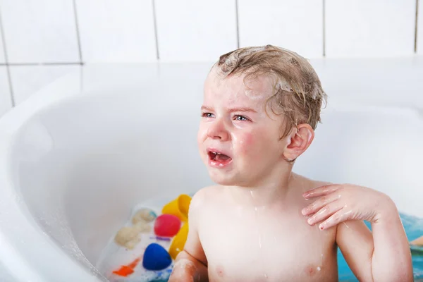 Cute little toddler boy of two years having fun by taking bath i — Stock Photo, Image