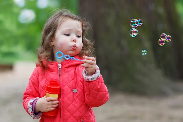 Söt liten flicka att ha kul med såpbubblor — Stockfoto