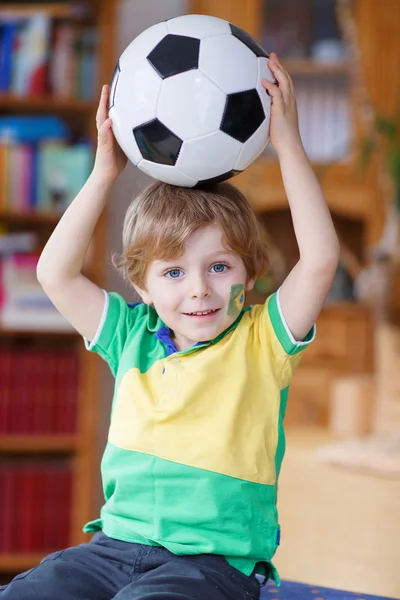 Little blond preschool boy of 4 years with football looking socc — Stock Photo, Image