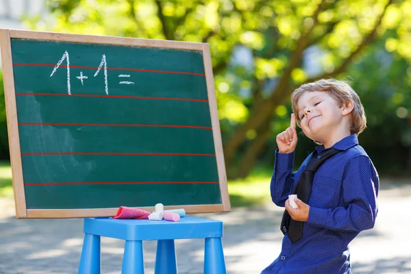 小男孩在黑板上练习数学 — 图库照片