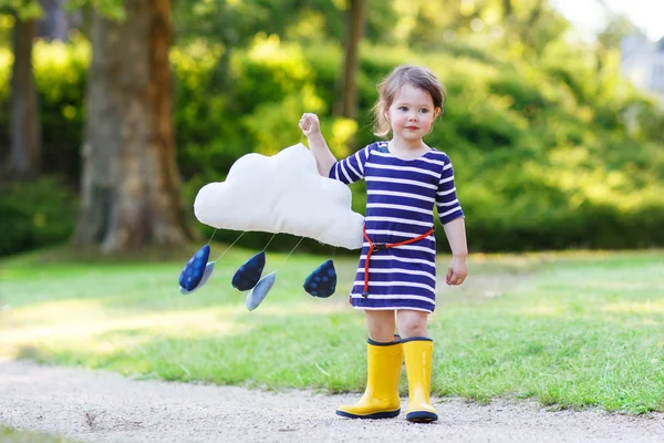 Cute toddler girl in yellow rubber boots — Stock Photo, Image