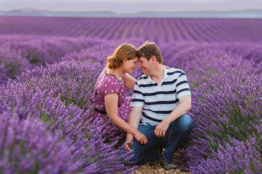 Romantic couple in love in lavender fields in Provence clipart
