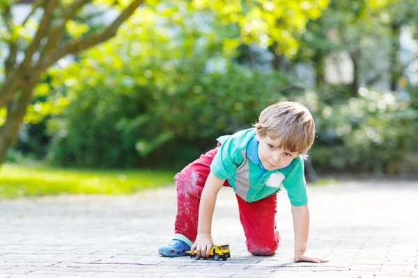 Little toddler boy playing with car toy — Stock Photo, Image
