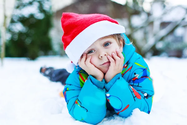Happy little toddler boy waiting for Christmas santa hat — Stock Photo, Image