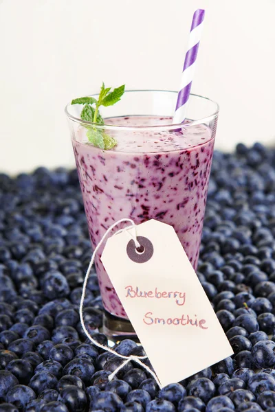 Blueberry smoothie in a glass jar with a straw and sprig of mint — Stock Photo, Image