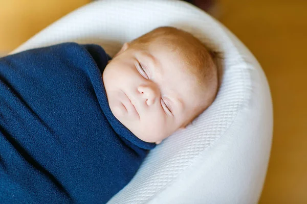 Cute adorable newborn baby wrapped in colorful blanket, sleeping and dreaming. Closeup of peaceful child, little baby girl . Family, Birth, new life. Swaddling as method for calm child. — Stock Photo, Image