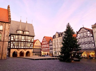 View of Alsfeld town hall, Weinhaus and church on main square, Germany. Historic city in Hesse, Vogelsberg, with old medieval frame half-timbered houses on Christmas time and tree. clipart