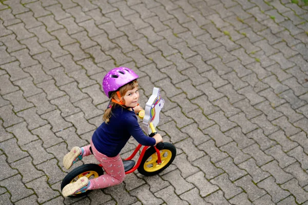 Little toddler girl running with balance bike on summer day. Happy child driving, biking with bicycle, outdoor activity. Happiness, childhood — Stock Photo, Image