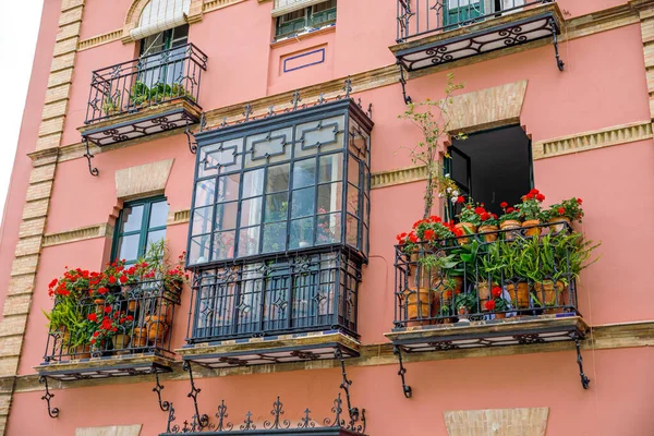 Decorative balconies and windows with gates of old city center house in Seville, Spain — Stock Photo, Image