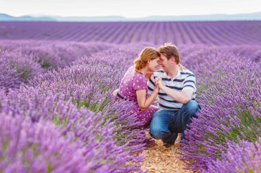 Romantik Çift Provence, Fransa lavanta alanlarındaki aşık. Güzel genç erkek ve kadın gün batımında sarılma. Düğün ya da nişan.