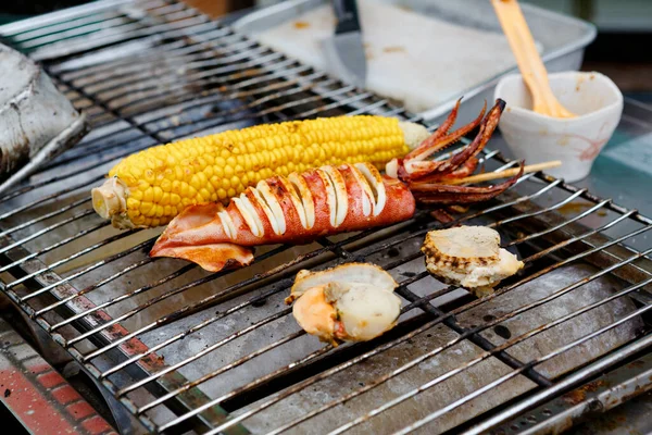 Japanse smakelijke street en fastfood: gegrilde inktvis, maïs en schaal-en schelpdieren. — Stockfoto