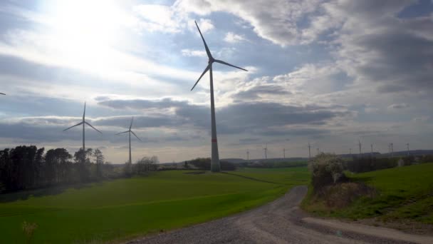 Panoramic view of wind farm or wind park on sunny day, with high wind turbines for generation electricity with copy space. Green energy concept. Video Stock Royalty Free